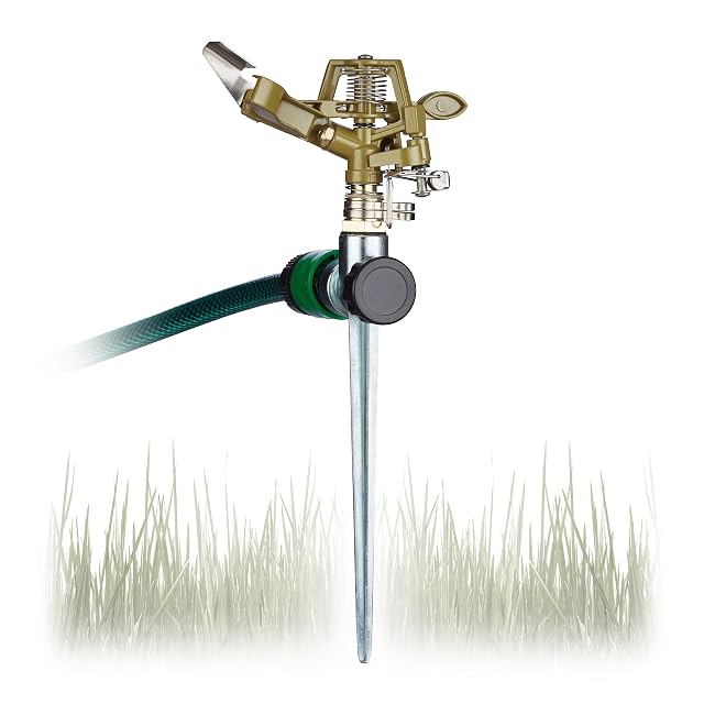 Grüner Impulssprinkler aus Metall auf einem Erdspieß